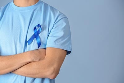 Man with blue ribbon-AdobeStock_185568814